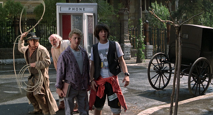 Dan Shor, George Carlin, Alex Winter, Keanu Reeves in BILL & TED'S EXCELLENT ADVENTURE (Orion Pictures Corporation)