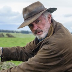 Sam Neill Says <em>Jurassic World: Dominion</em> Co-Star Chris Pratt Showed Him a Thing Or Two About Being An Action Star