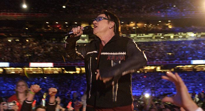 Bono, lead singer of U2, performs during the halftime show at Super Bowl XXXVI