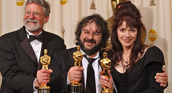 Barrie M. Osborne, Peter Jackson, and Fran Walsh holding Oscars for The Lord of the Rings: The Return of the King