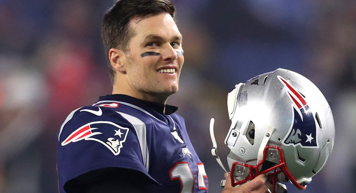 Tom Brady #12 of the New England Patriots looks on holding his helmet before the AFC Wild Card Playoff game against the Tennessee Titans at Gillette Stadium on January 04, 2020 in Foxborough, Massachusetts.