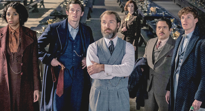 Jessica Williams, Callum Turner, Jude Law, Fiona Glascott, Dan Fogler, and Eddie Redmayne in a still from Fantastic Beasts: The Secrets of Dumbledore (2022