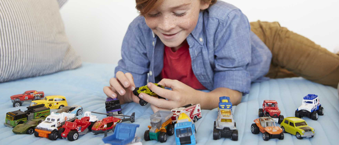 Boy plays with Matchbox toy cars