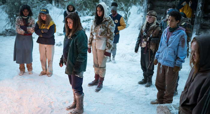 (L-R): Nuha Jes Izman as Teen Crystal, Samantha Hanratty as Teen Misty, Alexa Barajas as Teen Mari, Sophie Nélisse as Teen Shauna, Courtney Eaton as Teen Lottie, Nia Sondaya as Teen Akilah, Sophie Thatcher as Teen Natalie, Jasmin Savoy Brown as Teen Taissa, Steven Krueger as Ben Scott and Liv Hewson as Teen Van in YELLOWJACKETS. Photo Credit: Kailey Schwerman/SHOWTIME.