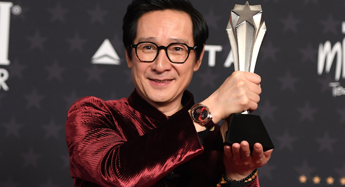 Ke Huy Quan posing with his trophy for Best Supporting Actor at the 28th Annual Critics Choice Awards