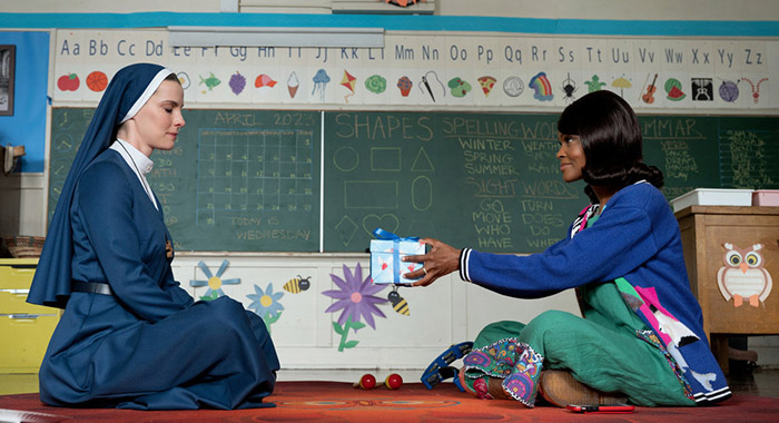 MRS. DAVIS -- Episode 101 -- Pictured: (l-r) Betty Gilpin as Simone, Kim Hawthorne as Teacher -- (Photo by: Colleen Hayes/Peacock)