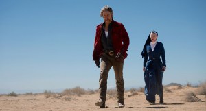 MRS. DAVIS -- "TBD" Episode 101 -- Pictured: (l-r) Jake McDorman as Wiley, Betty Gilpin as Simone -- (Photo by: Colleen Hayes/Peacock)