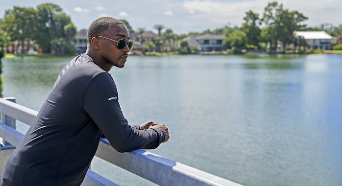 Anthony Mackie leans against a railing on the bridge he used to fish off as a child. He is overlooking Bayou St John. (National Geographic/Brian Roedel)