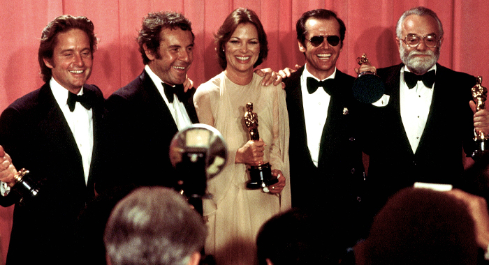 Producer Michael Douglas, director Miloš Forman, stars Louise Fletcher and Jack Nicolson, and producer Saul Zaentz celebrating backstage after winning multiple Oscars at the 48th Academy Awards in 1976
