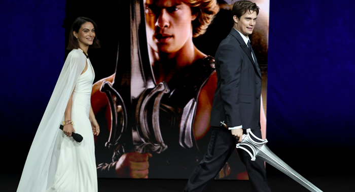 Camila Mendes and Nicholas Galitzine walk on stage to promote Masters of the Universe (2026)
